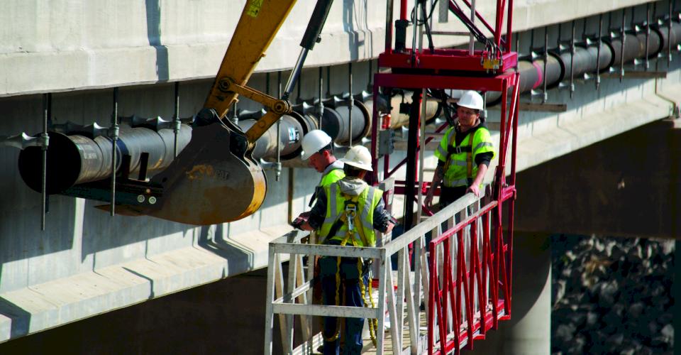 Installing ductile iron pipe bridge crossing.