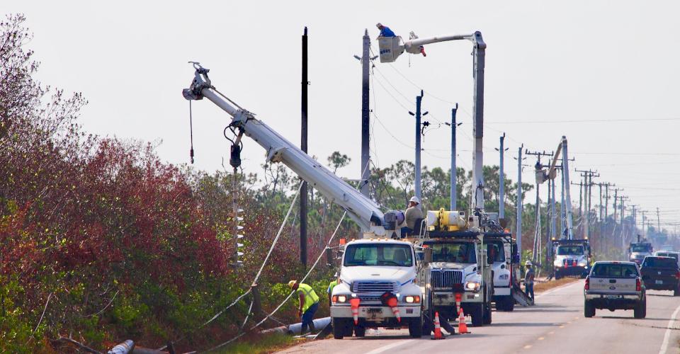 Crews install Ductile iron utility poles for electric after Hurricane Irma in Florida.