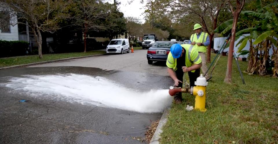 Crews flush a fire hydrant.