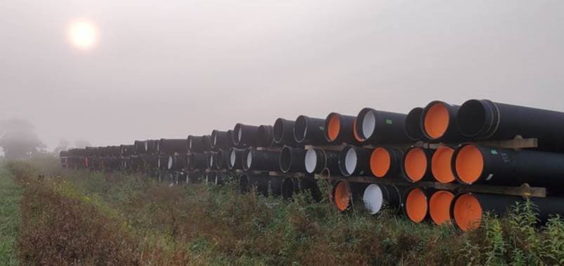 Ductile iron pipe with protective zinc coating and asphaltic topcoat awaits installation in South Dakota.
