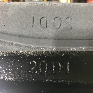 Required markings as-cast in the bell from the sand core as-molded.